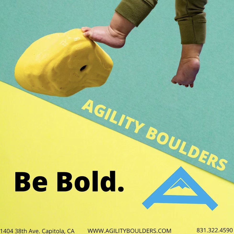 A teal and yellow advert: a baby's feet reaching for a yellow climbing hold, with 'Be Bold.' set large and the gym's address, website and phone number along the bottom.
