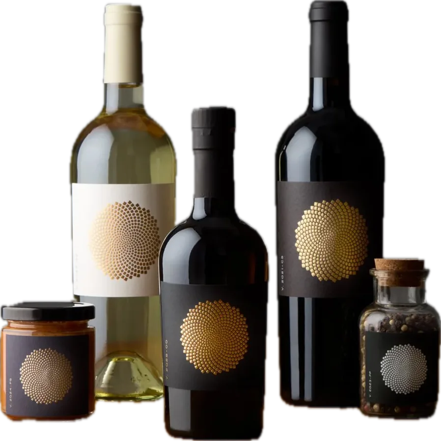 A private label range for Helena Viñedo: red and white wine bottles and two jars with gold dotted sunburst labels.