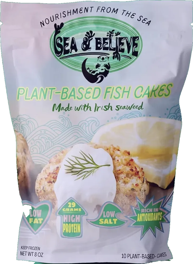 Sea & Believe plant-based fish cakes pouch: the otter badge above a photographed fish cake on a seaweed wave pattern.